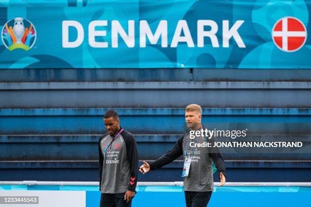 Denmark's defender Mathias Jorgensen and Denmark's forward Andreas Cornelius arrive for a training session at the team's training grounds in...