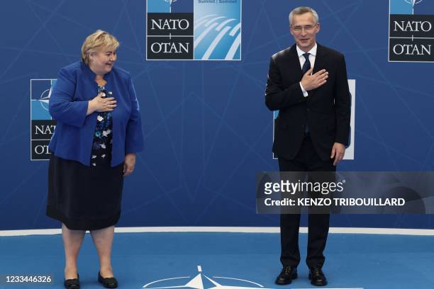 Norwegian Prime Minister Erna Solberg is greeted by NATO Secretary General Jens Stoltenberg during the NATO summit at the North Atlantic Treaty...