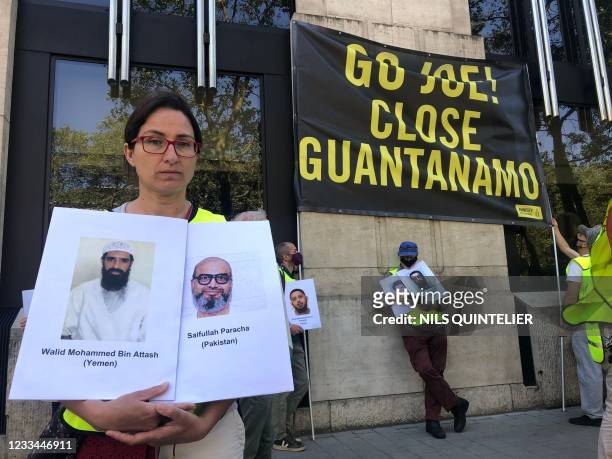 Amnesty International members protest to ask the closure of the Guantanamo Bay prison, at the US embassy in Brussels, on June 14 during the visit of...