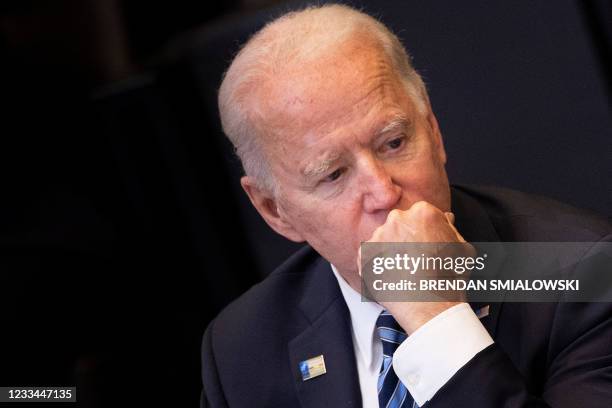 President Joe Biden listens on at the start of a meeting of the North Atlantic Council at the North Atlantic Treaty Organization headquarters in...