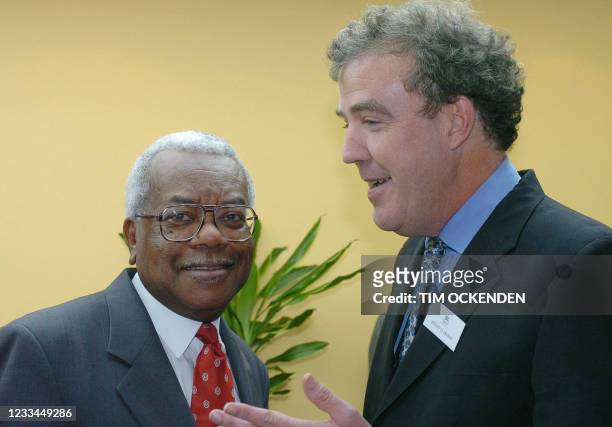 Broadcaster Sir Trevor McDonald and TV presenter Jeremy Clarkson speak during a visit by Britain's Queen Elizabeth II to Douglas House, a respite...