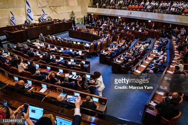 Incoming Prime Minister Naftali Bennett addresses the Knesset, Israel's parliament, before the vote of confidence was cast confirming the new...