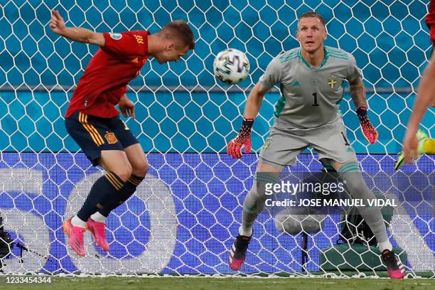 Spain's midfielder Daniel Olmo heads the ball past Sweden's goalkeeper Robin Olsen during the UEFA EURO 2020 Group E football match between Spain and...