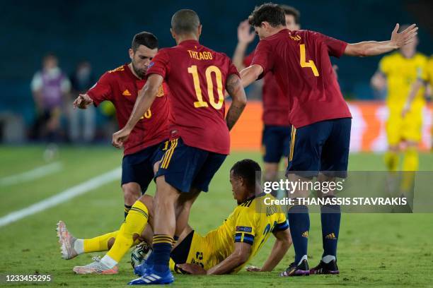 Sweden's midfielder Robin Quaison is marked by Spain's defender Pau Torres and Spain's midfielder Thiago Alcantara during the UEFA EURO 2020 Group E...