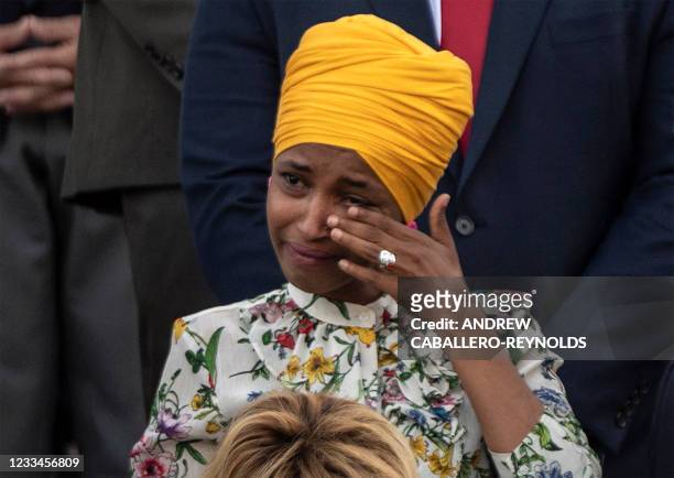 Representative Ilhan Omar cries during a moment of silence by congressional leaders to honor the 600,000 American lives lost to Covid-19 at the US...