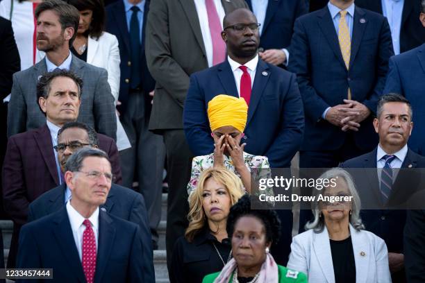 Rep. Ilhan Omar tears up as members of Congress hold a moment of silence for the 600,000 American lives lost to COVID-19, on the steps of the U.S....