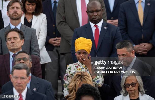 Representative Ilhan Omar cries during a moment of silence by congressional leaders to honor the 600,000 American lives lost to Covid-19 at the US...