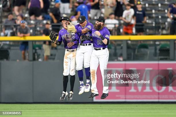 Colorado Rockies outfielders Raimel Tapia, Yonathan Daza, and Charlie Blackmon celebrate after a 3-2 win over the San Diego Padres at Coors Field on...