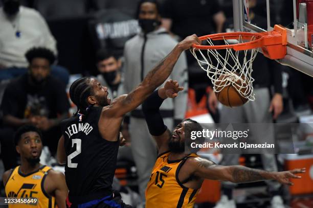 Kawhi Leonard of the Los Angeles Clippers slam dunks against Derrick Favors of the Utah Jazz during the first half in Game Four of the Western...