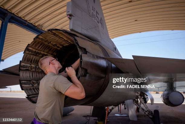 Air Force mechanic maintains an F-16 fighter jet after landing at an airbase in Ben Guerir, about 58 kilometres north of Marrakesh, during the...