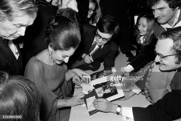Maria Callas signs autographs for her fans after her last recital at the Théatre des Champs Elysées in Paris on December 7, 1973.