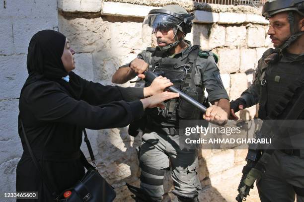 Palestinian woman confronts Israeli security forces outside the Damascus gate in east Jerusalem, on June 15 ahead of the March of the Flags which...