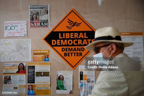 Volunteer stands in front of a Liberal Democrats sign at the headquarters of Liberal Democrats candidate Sarah Green on June 15, 2021 in Amersham,...