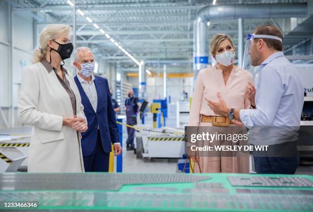 An employee of the Veluw Metal Creations company shows a metal piece to Dutch Queen Maxima in Nieuwkuijk, on June 15, 2021. The visit of Queen Maxima...