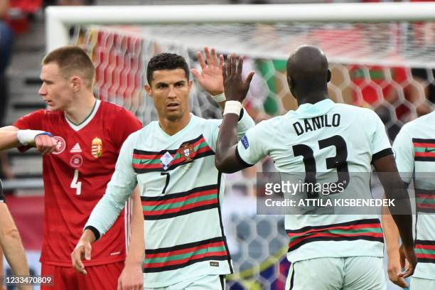Portugal's forward Cristiano Ronaldo celebrates with Portugal's midfielder Danilo Pereira their opening goal scored by Portugal's defender Raphael...