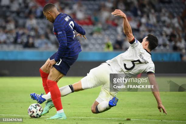 Germany's defender Mats Hummels tackles France's forward Kylian Mbappe during the UEFA EURO 2020 Group F football match between France and Germany at...
