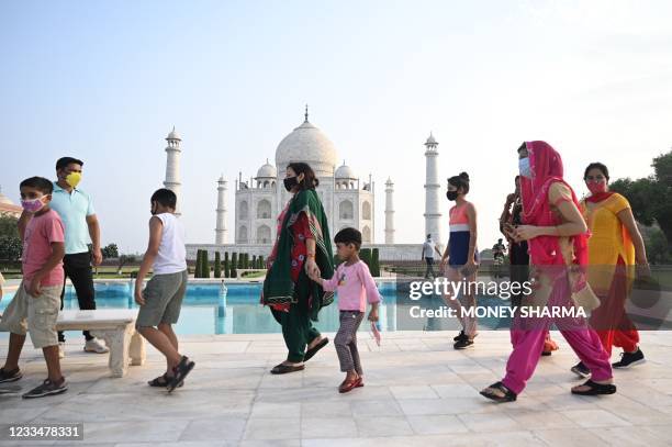 Tourists visit the Taj Mahal after it reopened to visitors following authorities easing Covid-19 coronavirus restrictions in Agra on June 16, 2021.