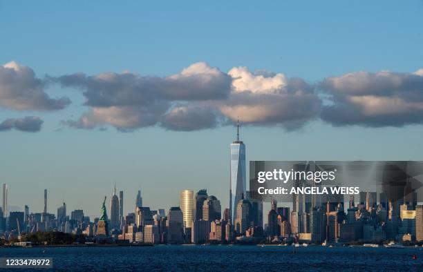 Clouds sit above the Manhattan skyline and Statue of Liberty on June 15, 2021 in New York City.