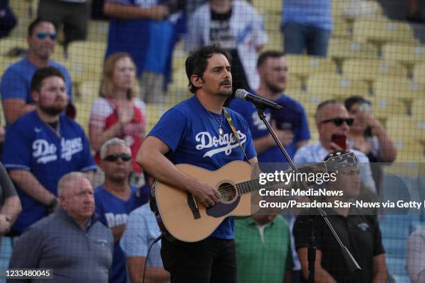 Los Angeles, CA Country singer Brad Paisley performs the National Anthem as Dodger fans fill Dodger Stadium which has been unavailable since the...