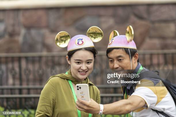 Members of the media wearing Mickey Mouse ears take a photograph during celebrations for the 5th anniversary of the Walt Disney Co. Shanghai...