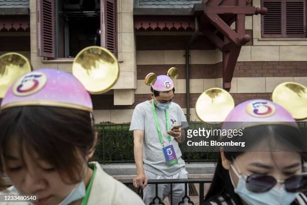 Member of the media wears Mickey Mouse ears during celebrations for the 5th anniversary of the Walt Disney Co. Shanghai Disneyland theme park at the...