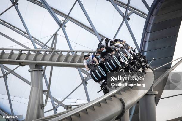Visitors ride the Tron Lightcycle Power Run roller coaster at the Walt Disney Co. Shanghai Disneyland theme park on the 5th anniversary of the...