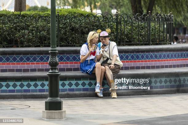 Visitor wears Mickey Mouse ears during celebrations for the 5th anniversary of the Walt Disney Co. Shanghai Disneyland theme park at the resort in...