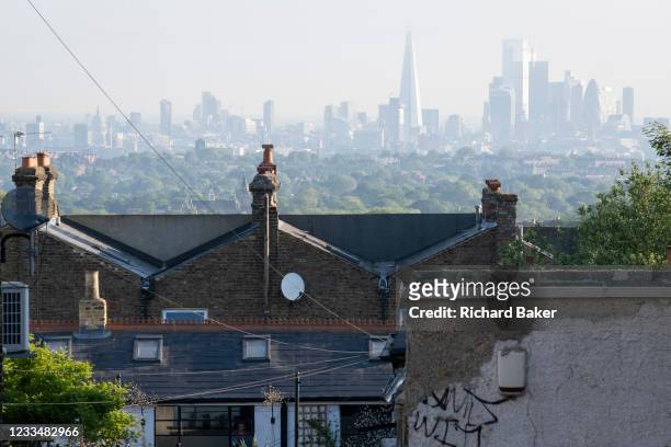 Houses and flats with an elevated viewpoint of the London skyline at Crystal Palace, on 16th June 2021, in London, England.