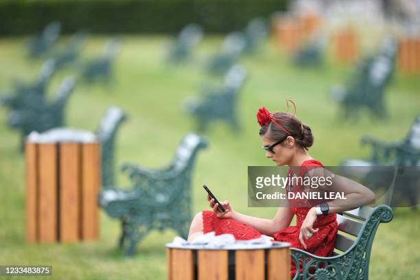 Racegoer gestures on the second day of the Royal Ascot horse racing meet, in Ascot, west of London on June 16, 2021. - Royal Ascot reopened its doors...