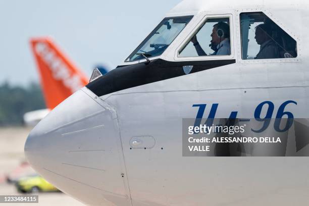 Pilots of the Ilyushin Il-96 airplane carrying Russian president Vladimir Putin taxis on Cointrin airport apron as he arrives ahead of his meeting...
