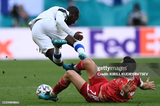 Finland's midfielder Glen Kamara and Russia's midfielder Magomed Ozdoev vie during the UEFA EURO 2020 Group B football match between Finland and...