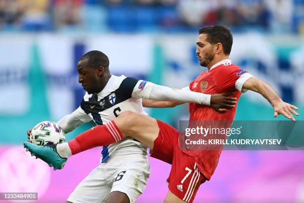 Finland's midfielder Glen Kamara and Russia's midfielder Magomed Ozdoev vie during the UEFA EURO 2020 Group B football match between Finland and...