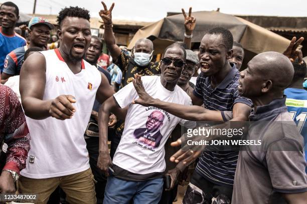 Supporters of former Ivory Coast President Laurent Gbagbo sing and dance in the popular neighbourhood of Yopougon in Abidjan on June 16, 2021. -...