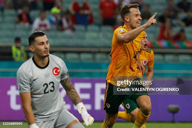 Wales' midfielder Aaron Ramsey celebrates after scoring his opening goal next to Turkey's goalkeeper Ugurcan Cakir during the UEFA EURO 2020 Group A...