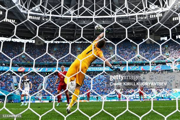 Finland's goalkeeper Lucas Hradecky concedes the opening goal goal shot by Russia's forward Aleksey Miranchuk during the UEFA EURO 2020 Group B...