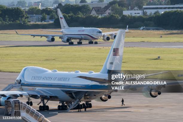 Air Force One, the Boeing-747 airplane of US President Joe Biden, bottom, stands by, as the presidential Iljuschin Il-96, presumably carrying Russian...