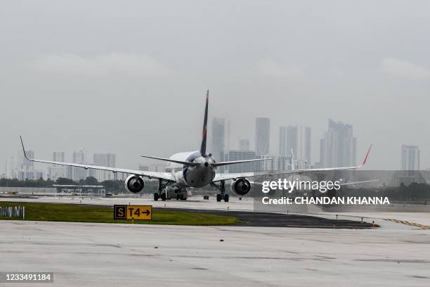 Commercial Airplanes are seen on the runway at the Miami International Airport in Miami, on June 16, 2021.