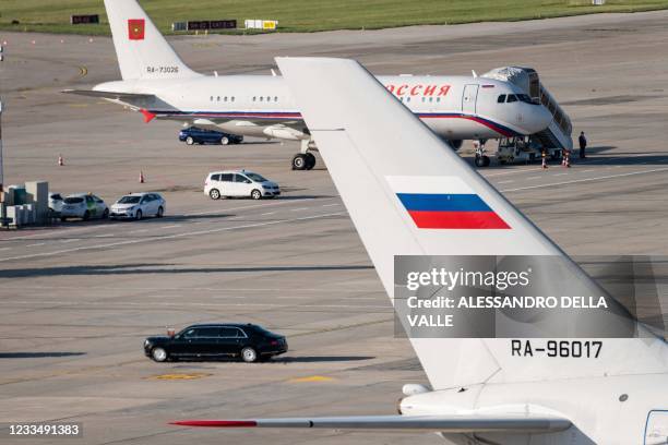 One of the limousines of Russian president Vladimir Putin approaches the Russian airplanes, after the US - Russia summit with US President Joe Biden,...