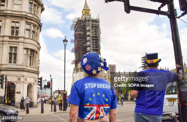 Protester wearing a Stop Brexit shirt stands outside the Houses of Parliament during a small anti-Brexit and anti-Tory government demonstration in...