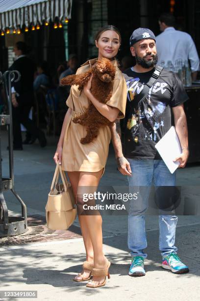 Olivia Culpo is seen holding a dog while leaving Gemma restaurant on June 15, 2021 in New York City, New York.
