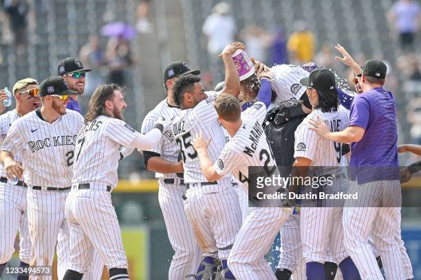 Charlie Blackmon of the Colorado Rockies celebrates with teammates after hitting a ninth inning walk off RBI single against the San Diego Padres at...