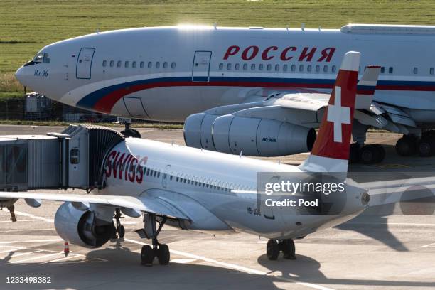 The presidential Ilyushin Il-96, believed to be carrying Russian president Vladimir Putin, top, passes a Swiss commercial airliner at Geneva Airport...