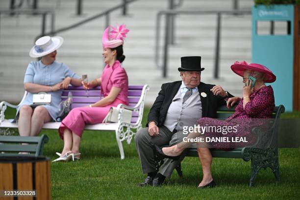 Racegoers relax in the Royal Enclosure on Ladies Day at the Royal Ascot horse racing meet, in Ascot, west of London on June 17, 2021. - Royal Ascot...