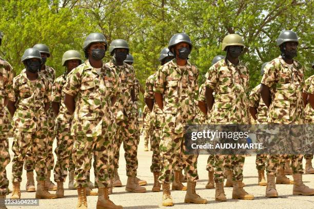 Soldiers stand on guard during Nigerian President Muhammadu Buhari's visit to the Maimalari Barracks in Maiduguri on June 17, 2021.