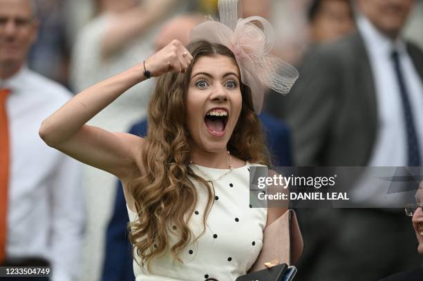 Racegoer cheers on her selection in the Hampton Court Stakes on Ladies Day at the Royal Ascot horse racing meet, in Ascot, west of London on June 17,...