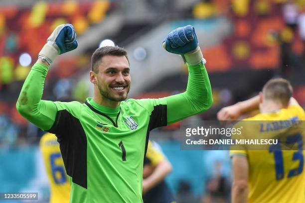 Ukraine's goalkeeper Georgiy Bushchan celebrates after winning the UEFA EURO 2020 Group C football match between Ukraine and North Macedonia at the...