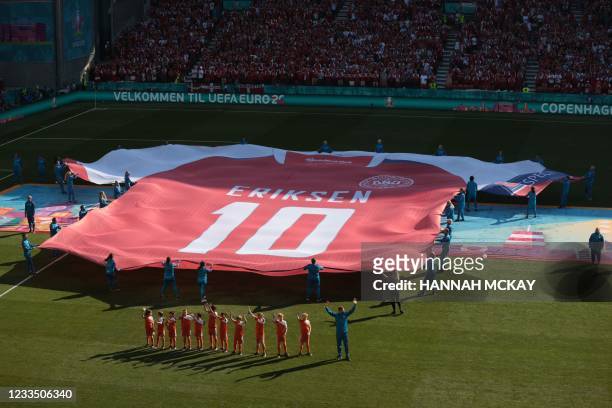 Giant jersey of Denmark's midfielder Christian Eriksen is put on display on the pitch before the start of the UEFA EURO 2020 Group B football match...