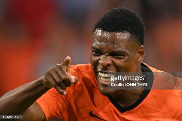 Netherlands' defender Denzel Dumfries celebrates scoring his team's second goal during the UEFA EURO 2020 Group C football match between the...