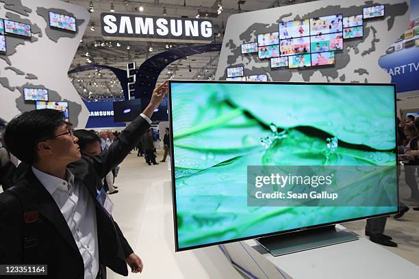 Visitor checks out a Samsung Smart TV television at the Samsung hall at the IFA 2011 consumer electonics and appliances trade fair on the first day...