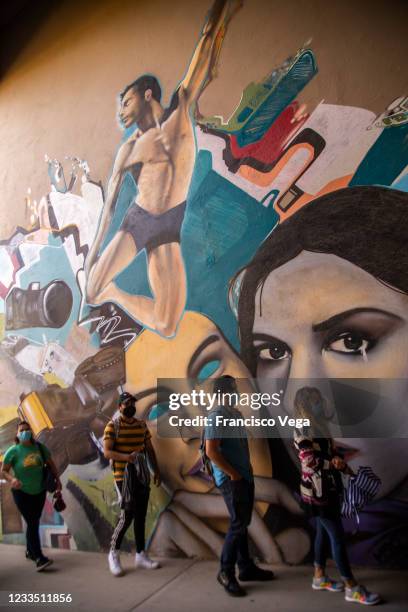 Citizens line up outside a vaccination center to receive the Johnson & Johnson vaccine against Covid-19 at Universidad de Baja California on June 17,...